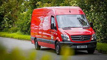 Van close up driving down a country road